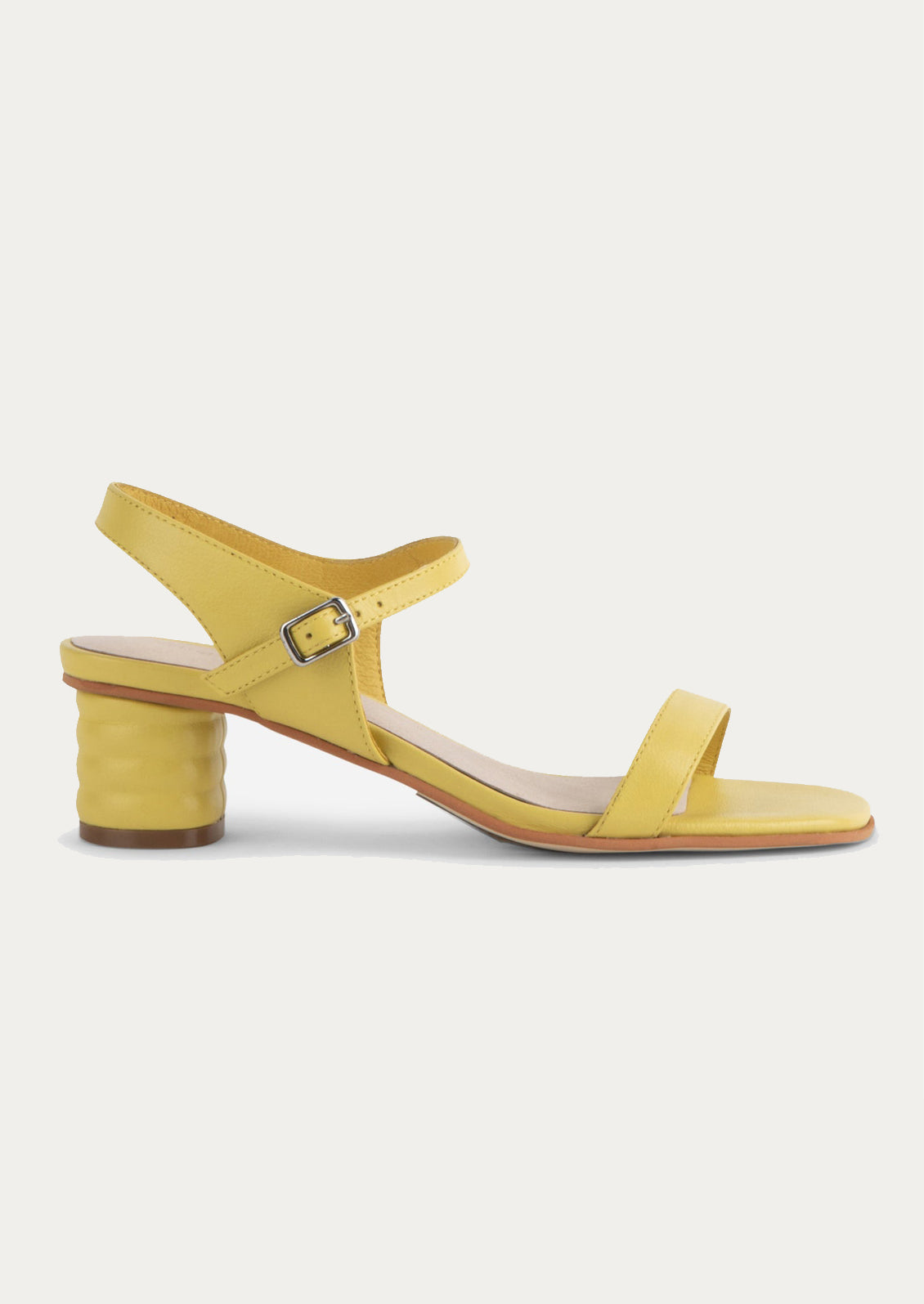 A pair of heeled leather sandals in lemon yellow.
