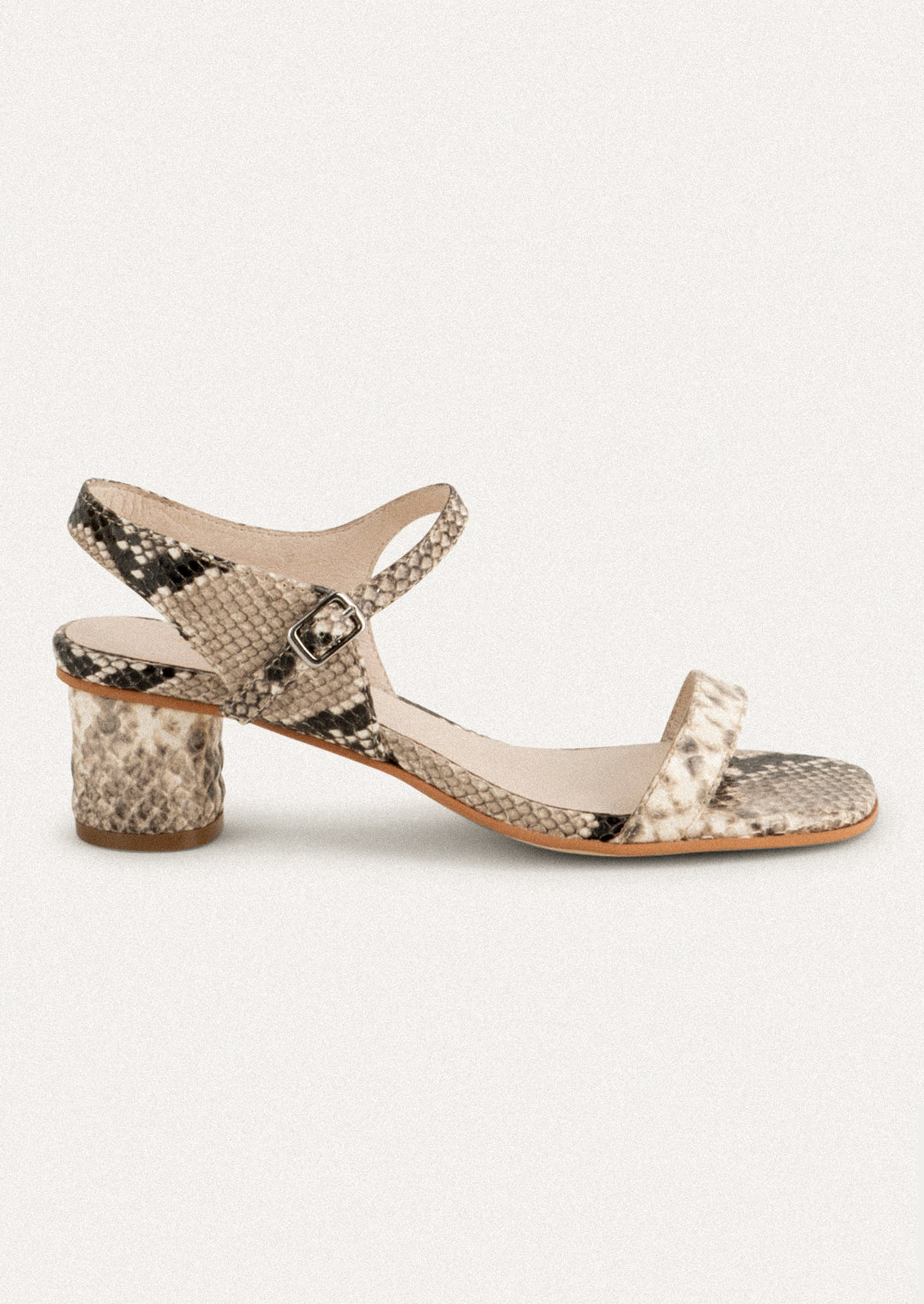 A pair of heeled leather sandals in snakeskin.