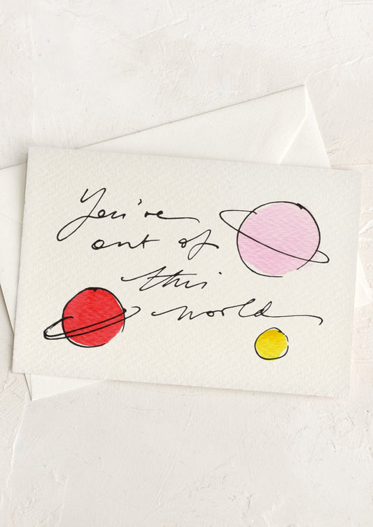 Card with 'You're out of this world' text and colorful planets on a white background