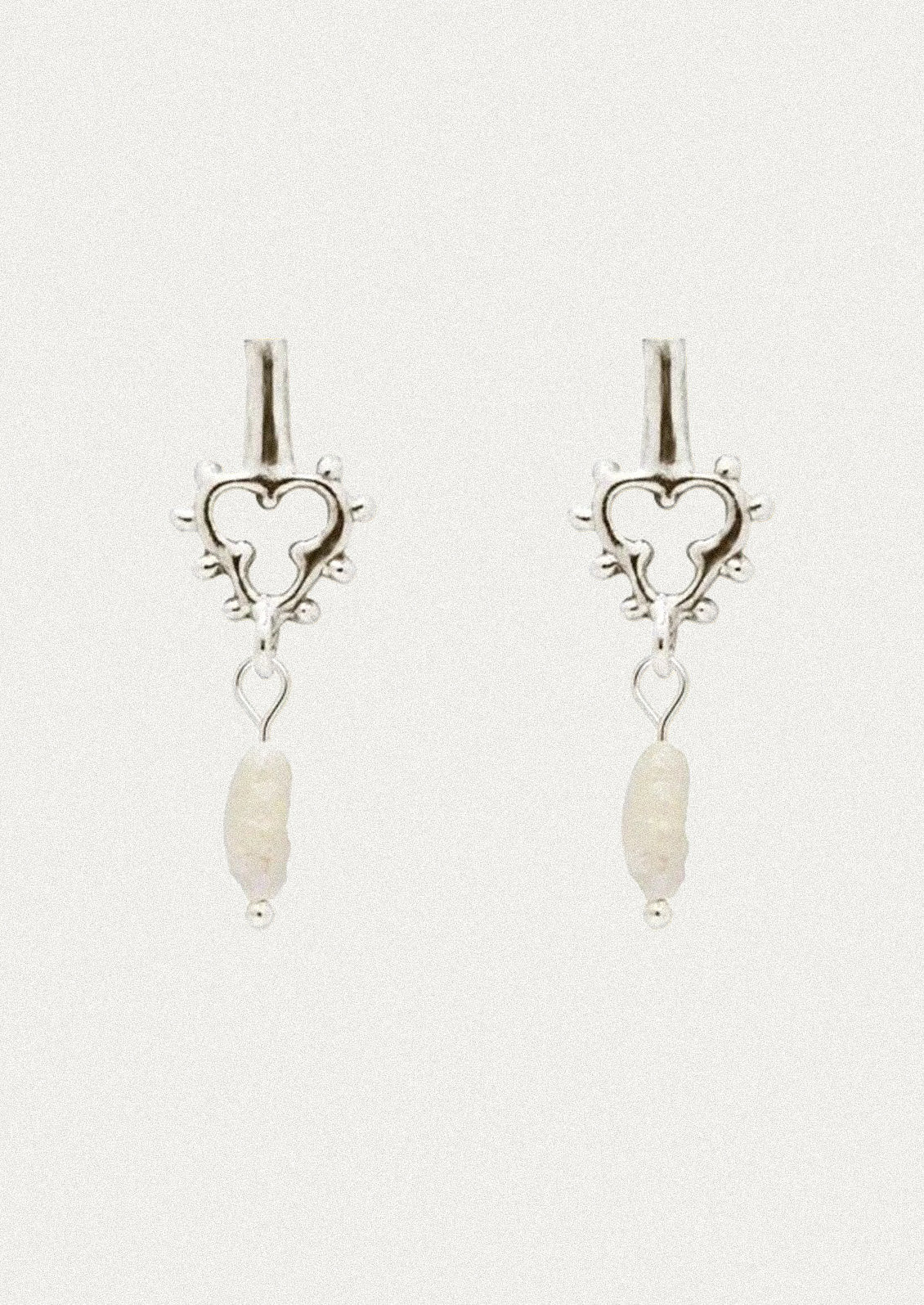 A pair of unique sterling silver earrings with a dangling keshi pearl.
