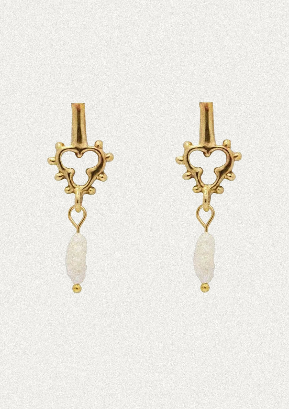 A pair of unique brass earrings with a dangling keshi pearl.