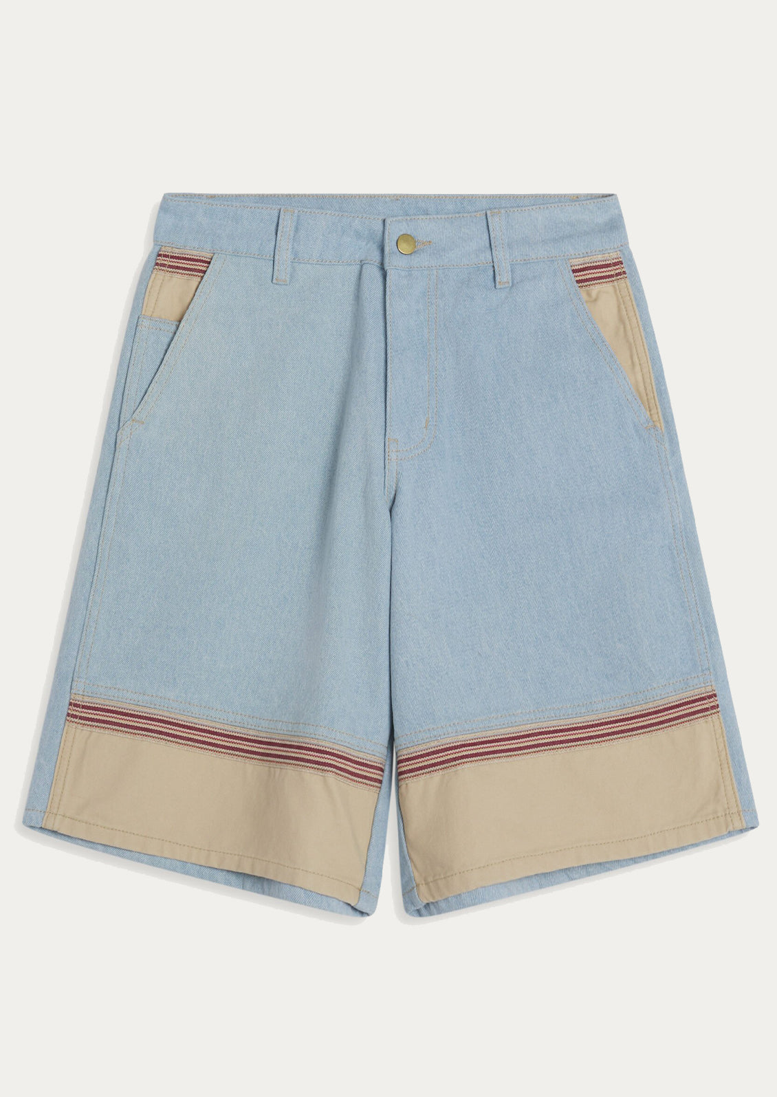 A woman wearing a pair of light denim bermuda shorts with contrast fabric at front hem.