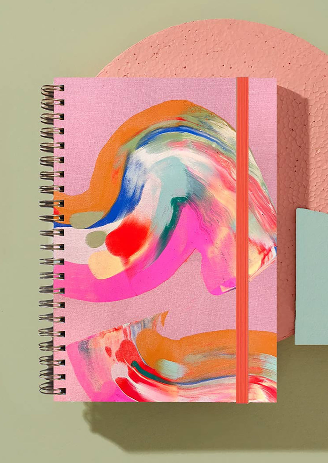 A multicolor painted notebook in pink.