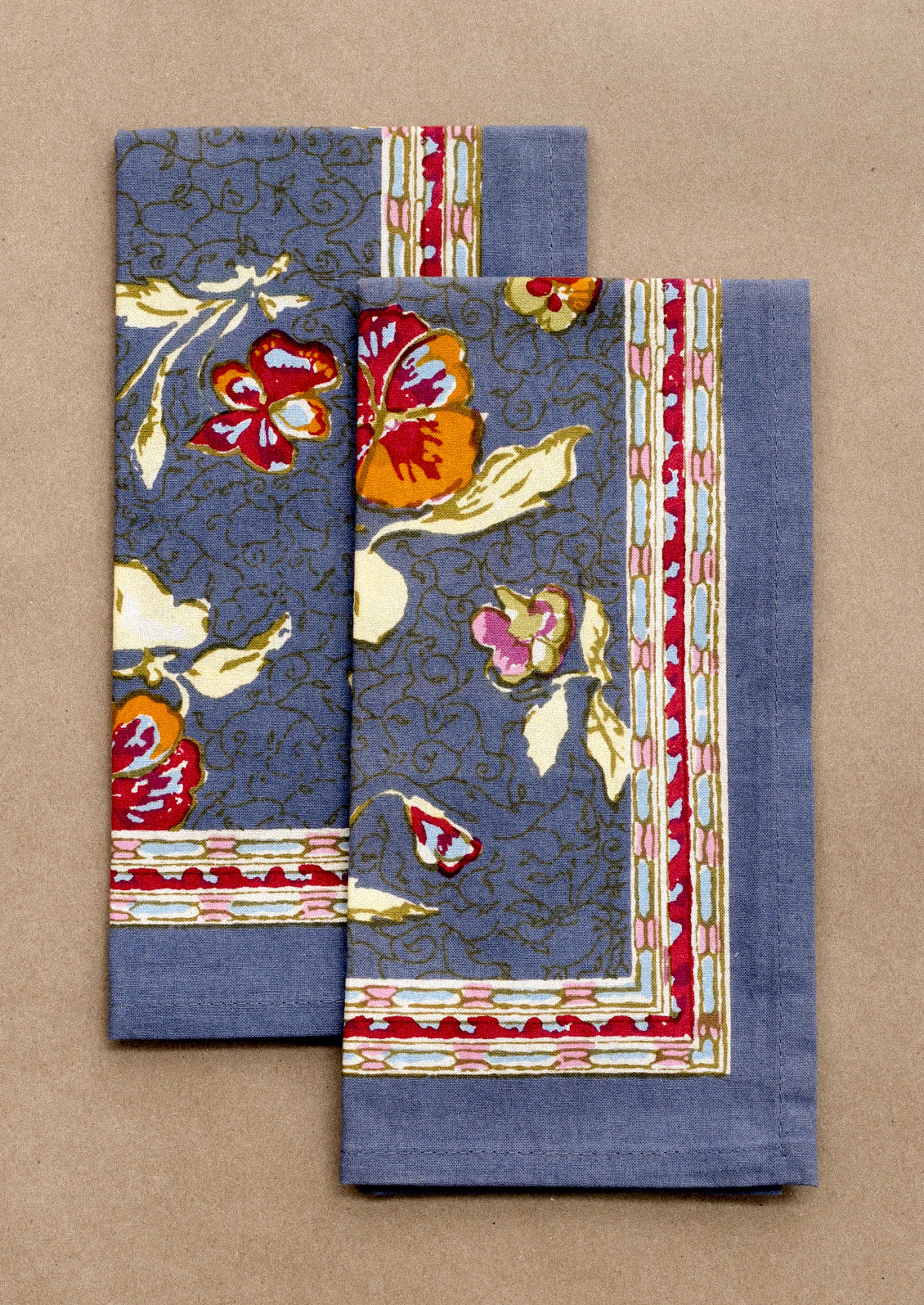 Set of two floral-patterned napkins on a beige background