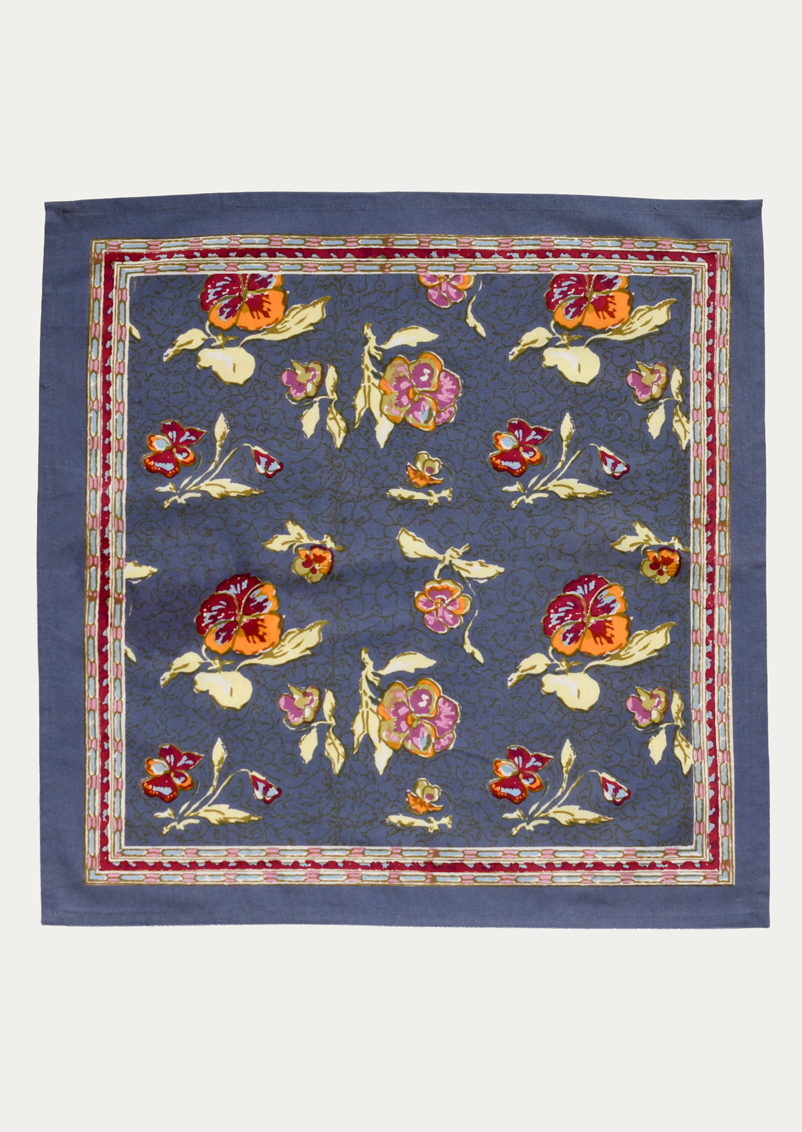 Floral patterned fabric square on a blue background