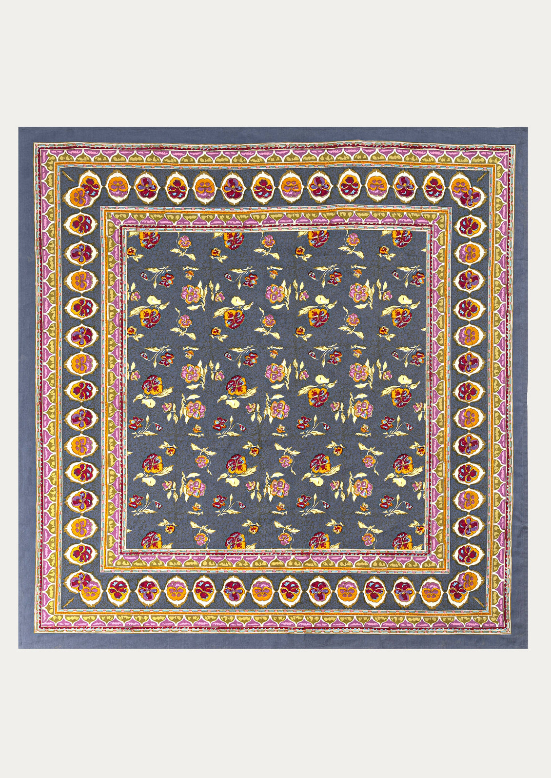 Decorative tablecloth with floral pattern and colorful border on a blue background