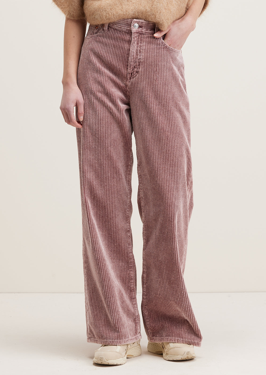 A pair of wide corduroy pants with wide leg and slouchy fit, in dusty mauve color.