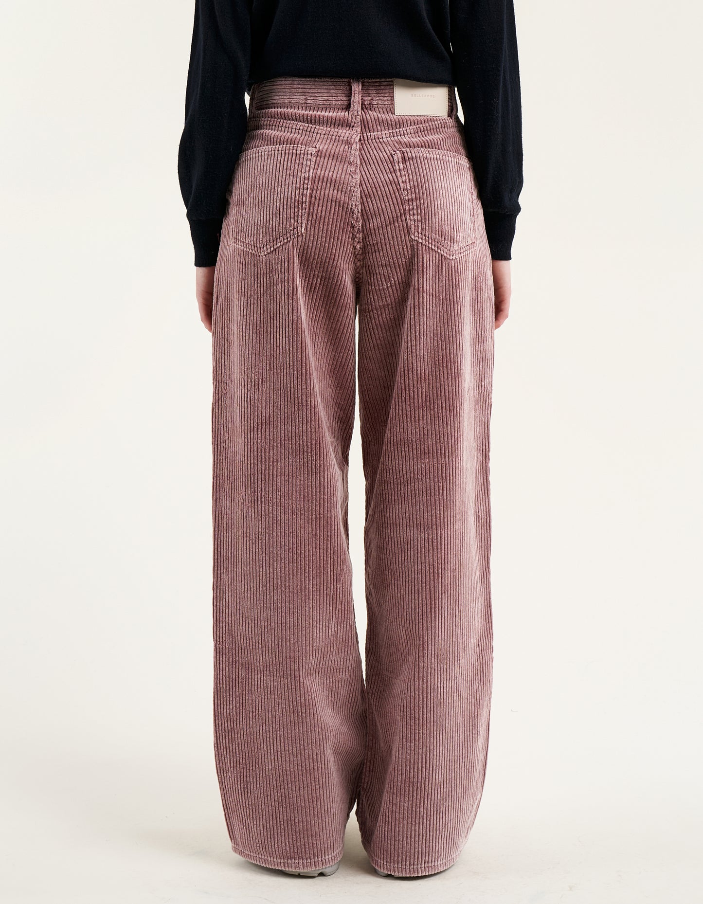 A pair of wide corduroy pants with wide leg and slouchy fit, in dusty mauve color.