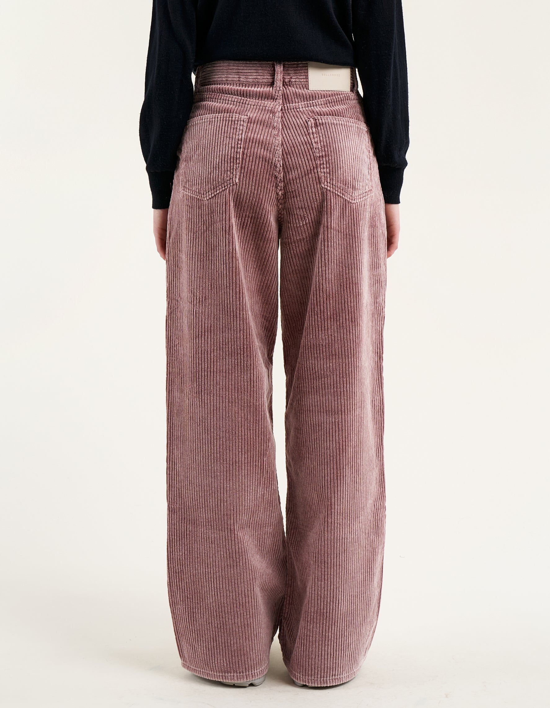 A pair of wide corduroy pants with wide leg and slouchy fit, in dusty mauve color.