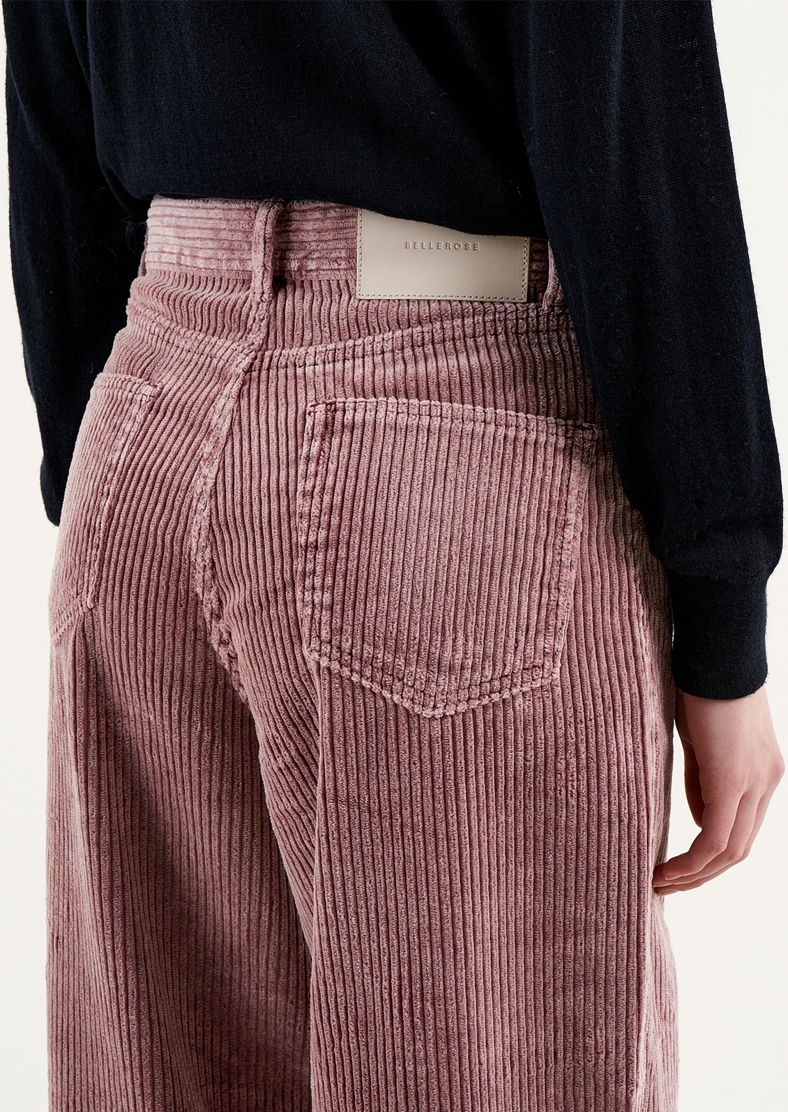 A pair of wide corduroy pants with wide leg and slouchy fit, in dusty mauve color.