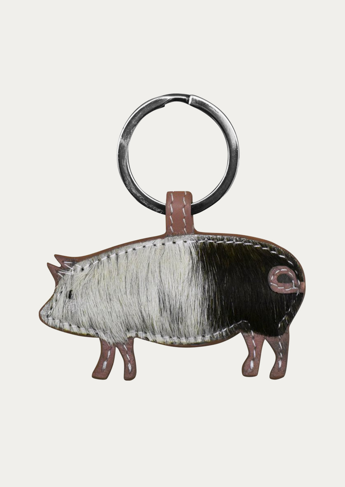 A leather pig keychain in with a mauve border.