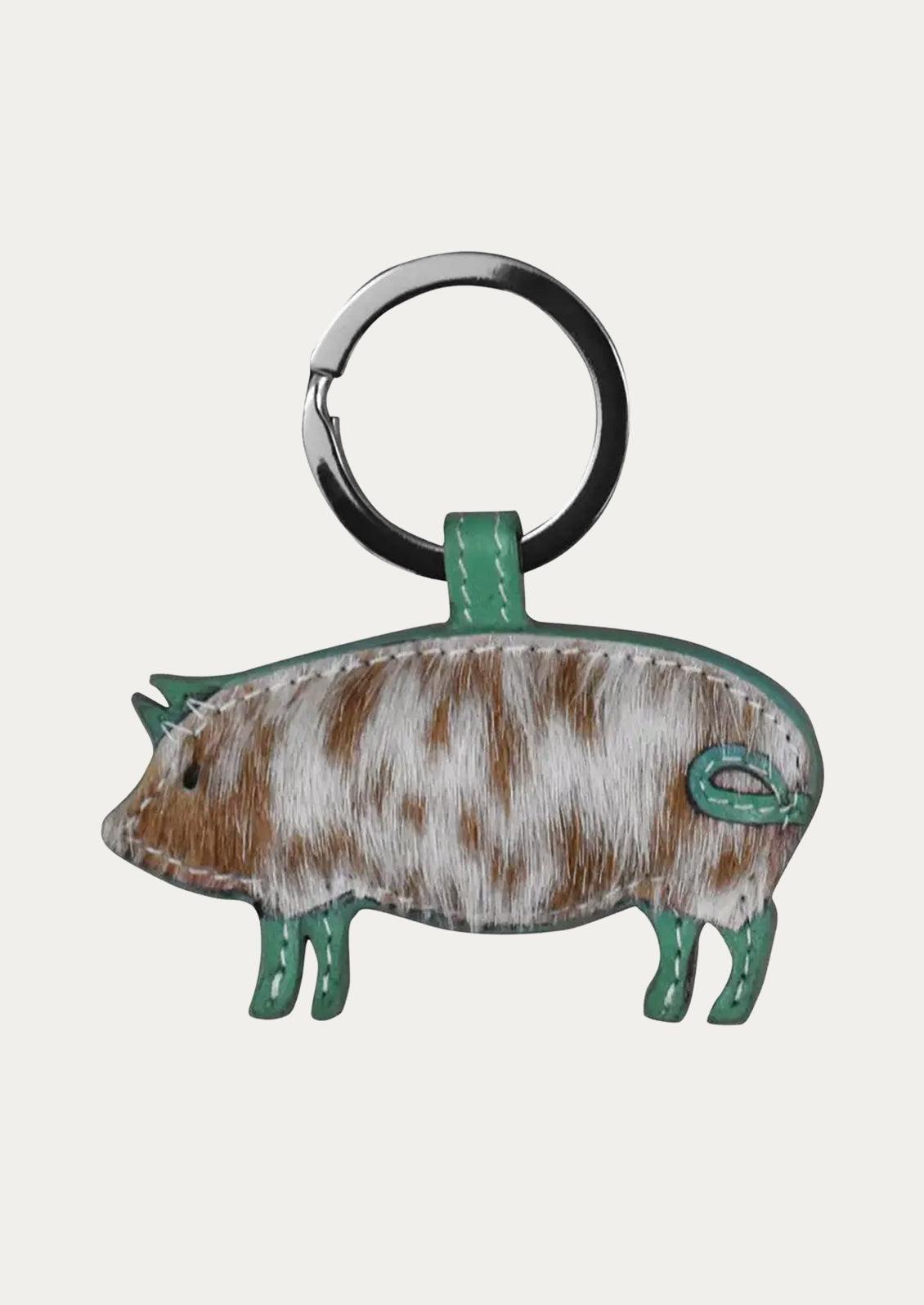 A leather pig keychain in with a turquoise border.