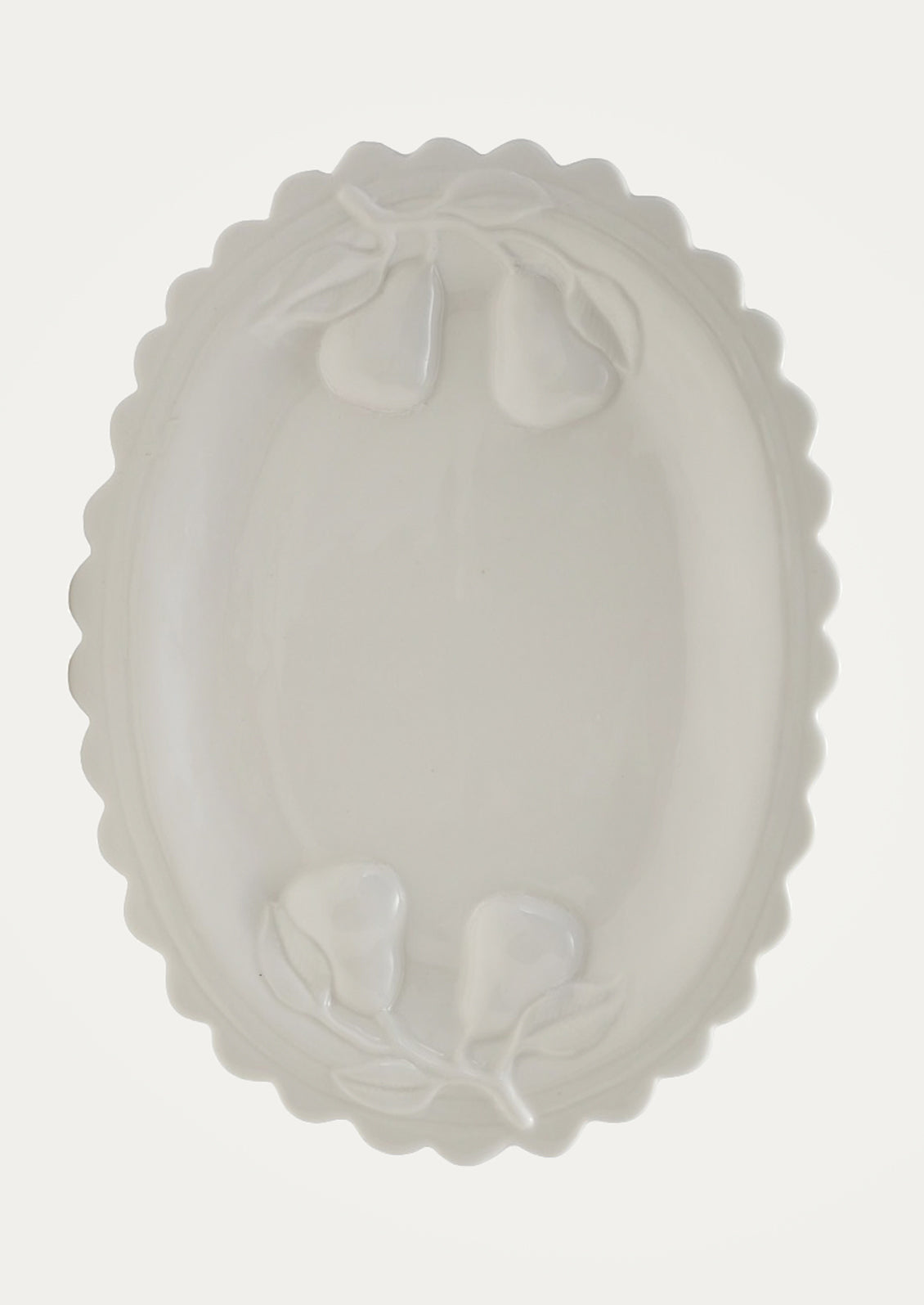 White platter with embossed pear design on a light gray background