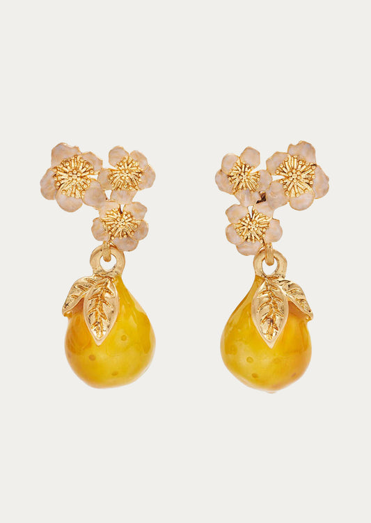 A pair of golden pear drop earrings adorned with light pink flowers.