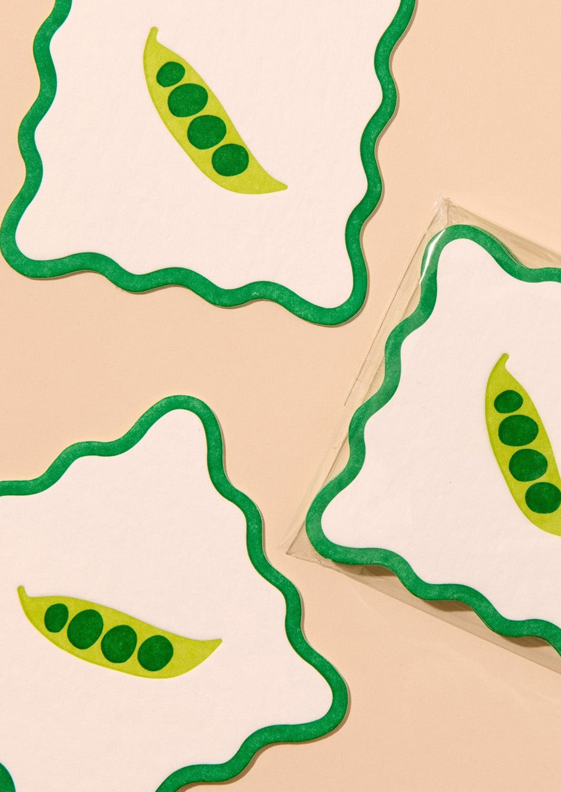 Decorative paper coasters with wavy edges and green pea motif.