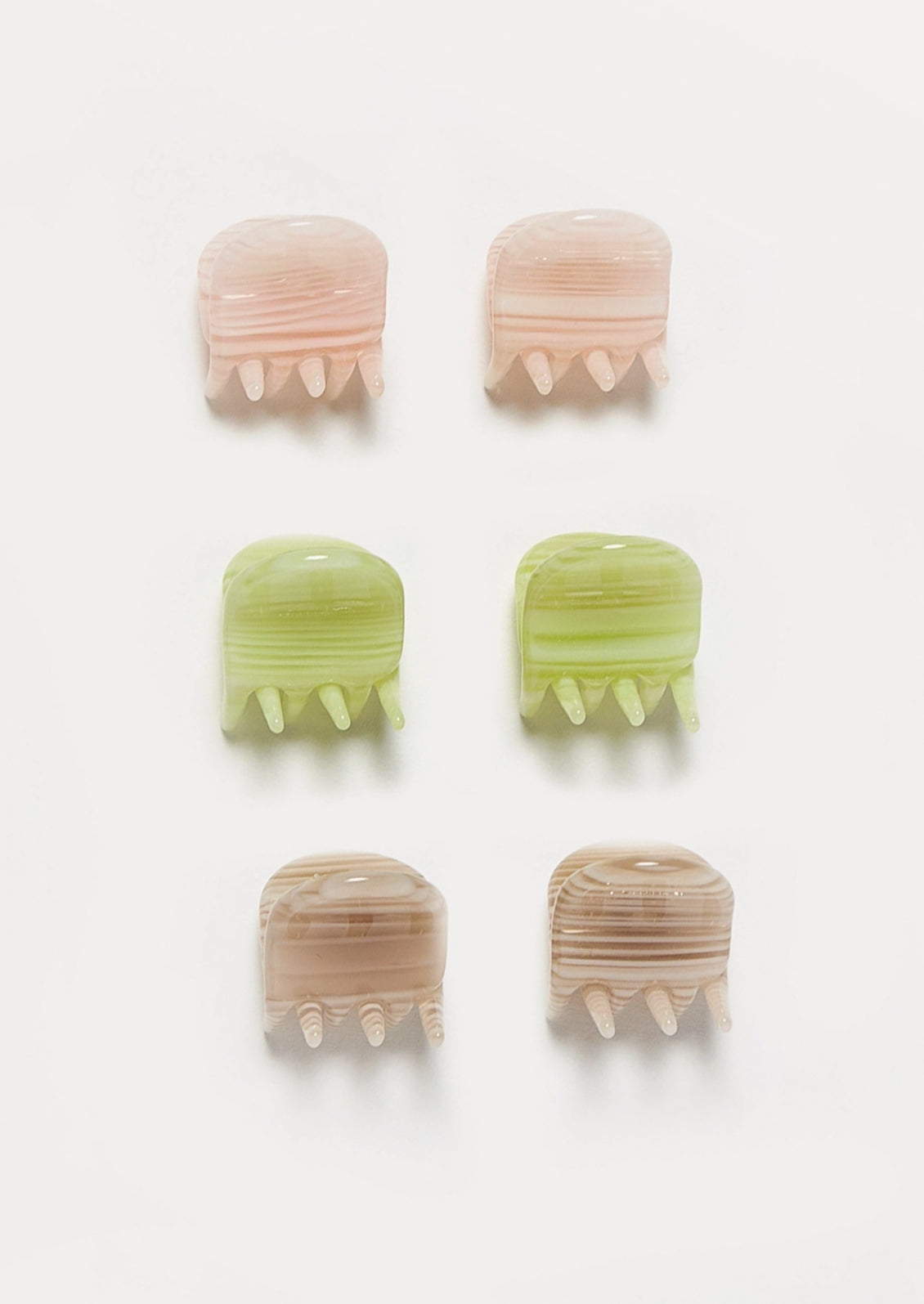 A set of 6 pink, green, and brown mini hair claws.