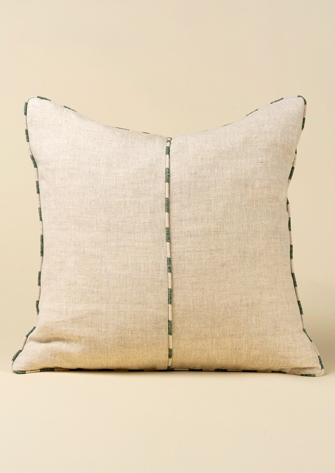 Natural linen pillow with a central stripe on a beige background