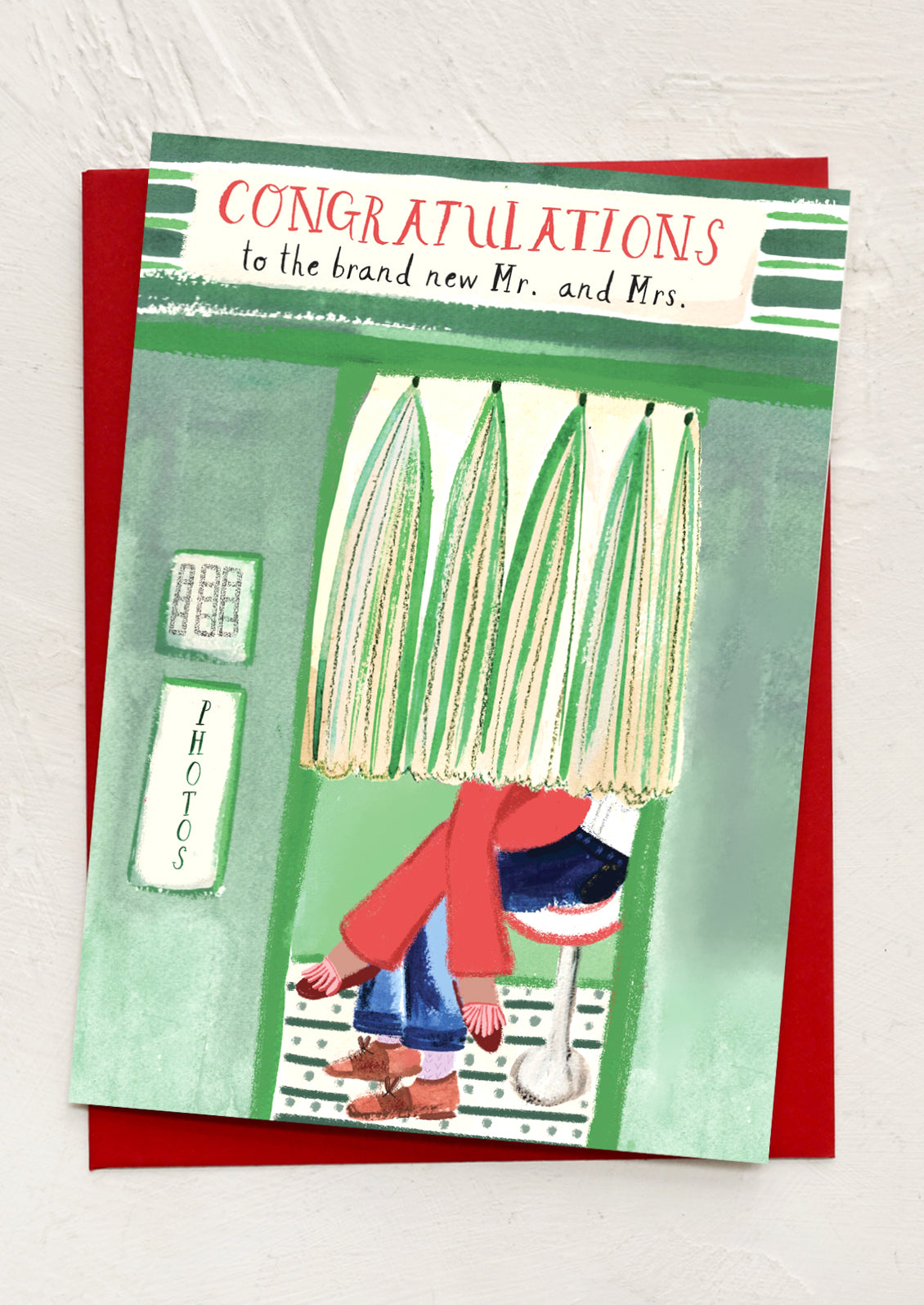 Wedding card with illustration of a couple inside a photo booth, text 'Congratulations to the brand new Mr. and Mrs.'