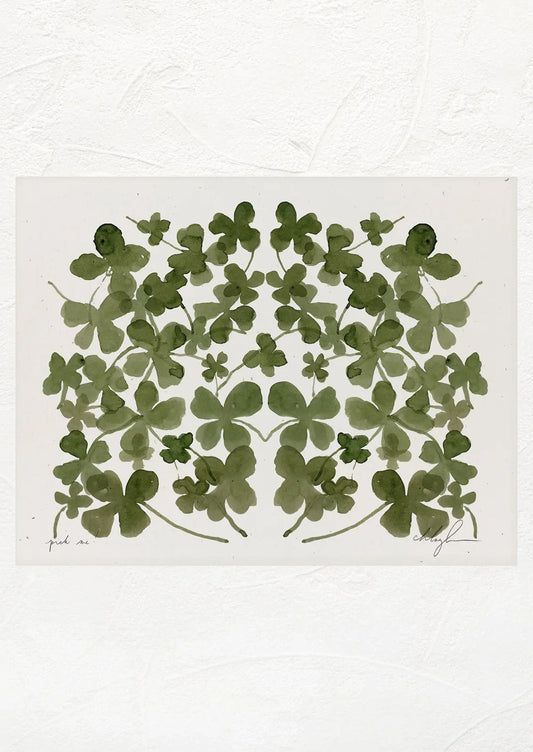 An art print with a mirrored image of multiple four leaf clovers.