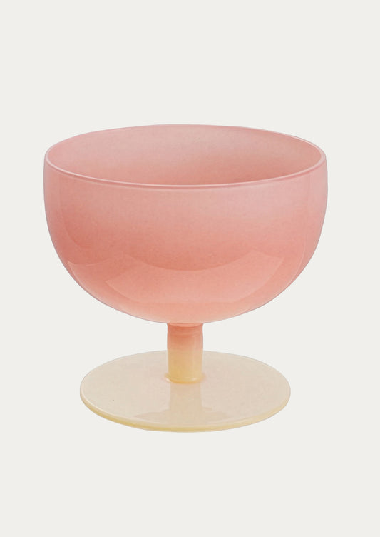 Pink glass with a thin stem on a white background