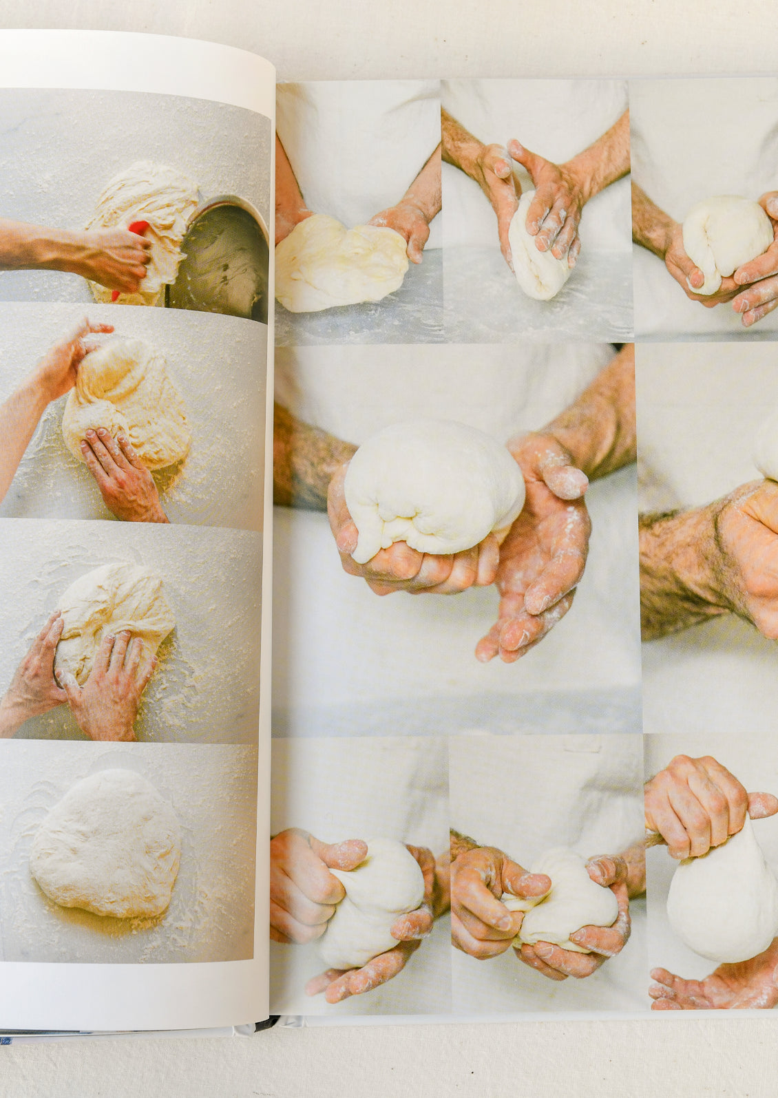 A book open on a table showing images of how to shape pizza dough.