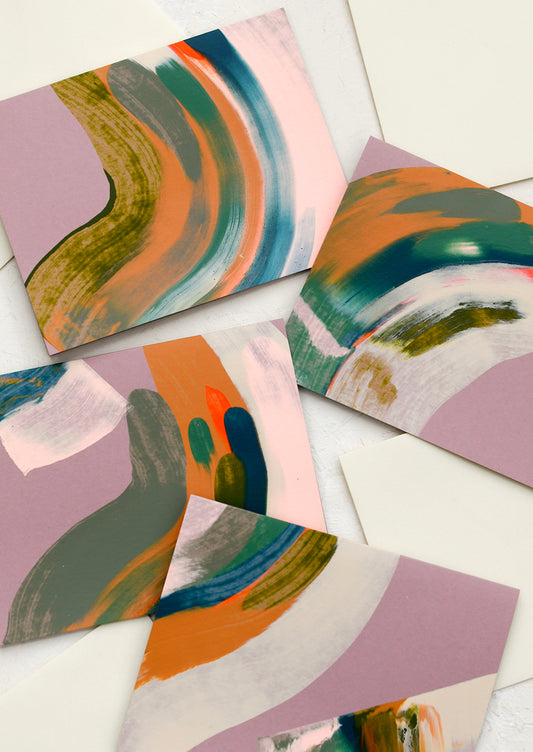 A set of abstract painted cards in mauve color.