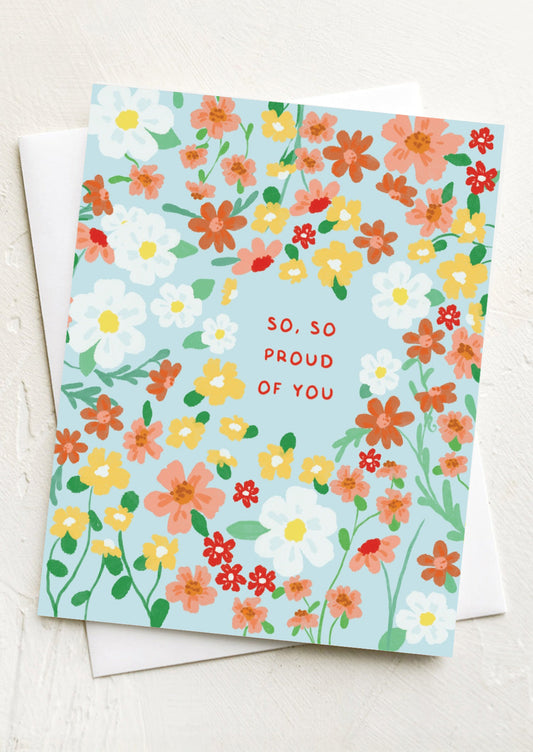 A floral print card with text reading "So, so proud of you.