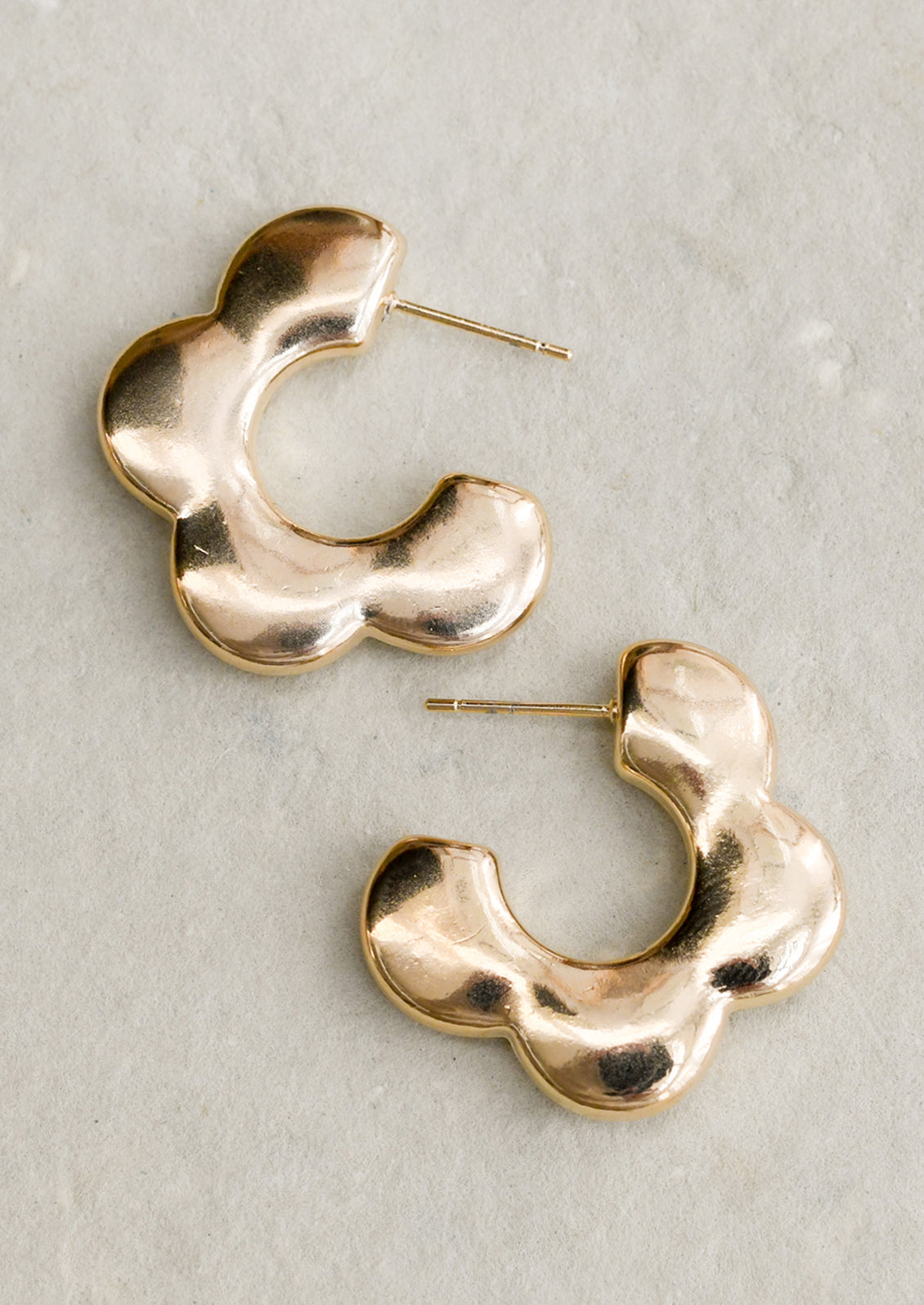 A pair of post back earrings with 3/4 flower shape with puffy look.