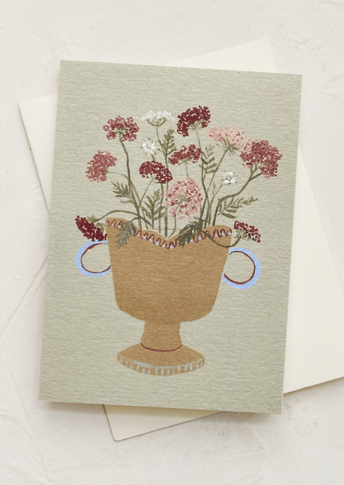A mini greeting card in sage green with illustration of queen anne's lace in pot.