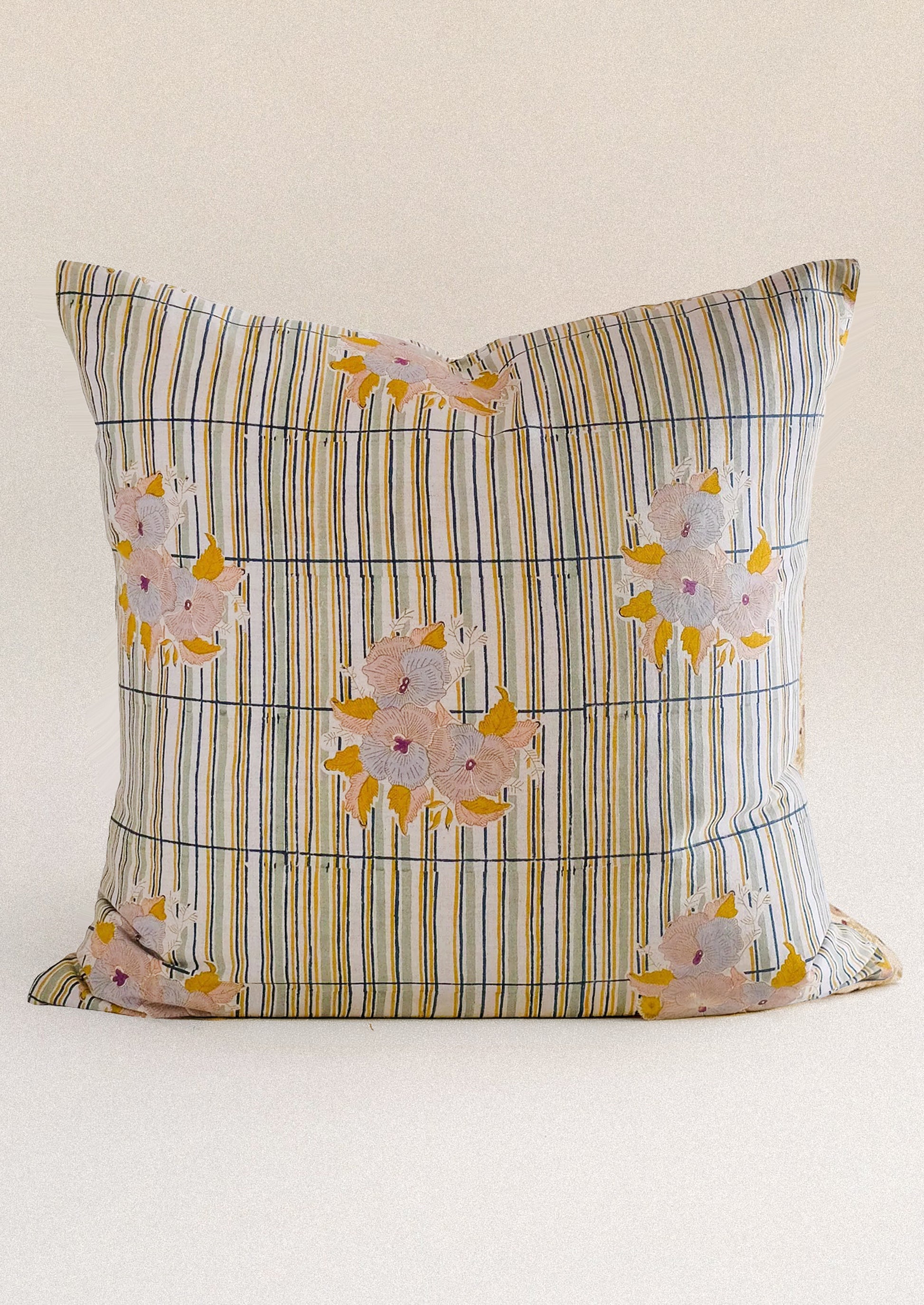 A throw pillow with stripe and floral pattern.