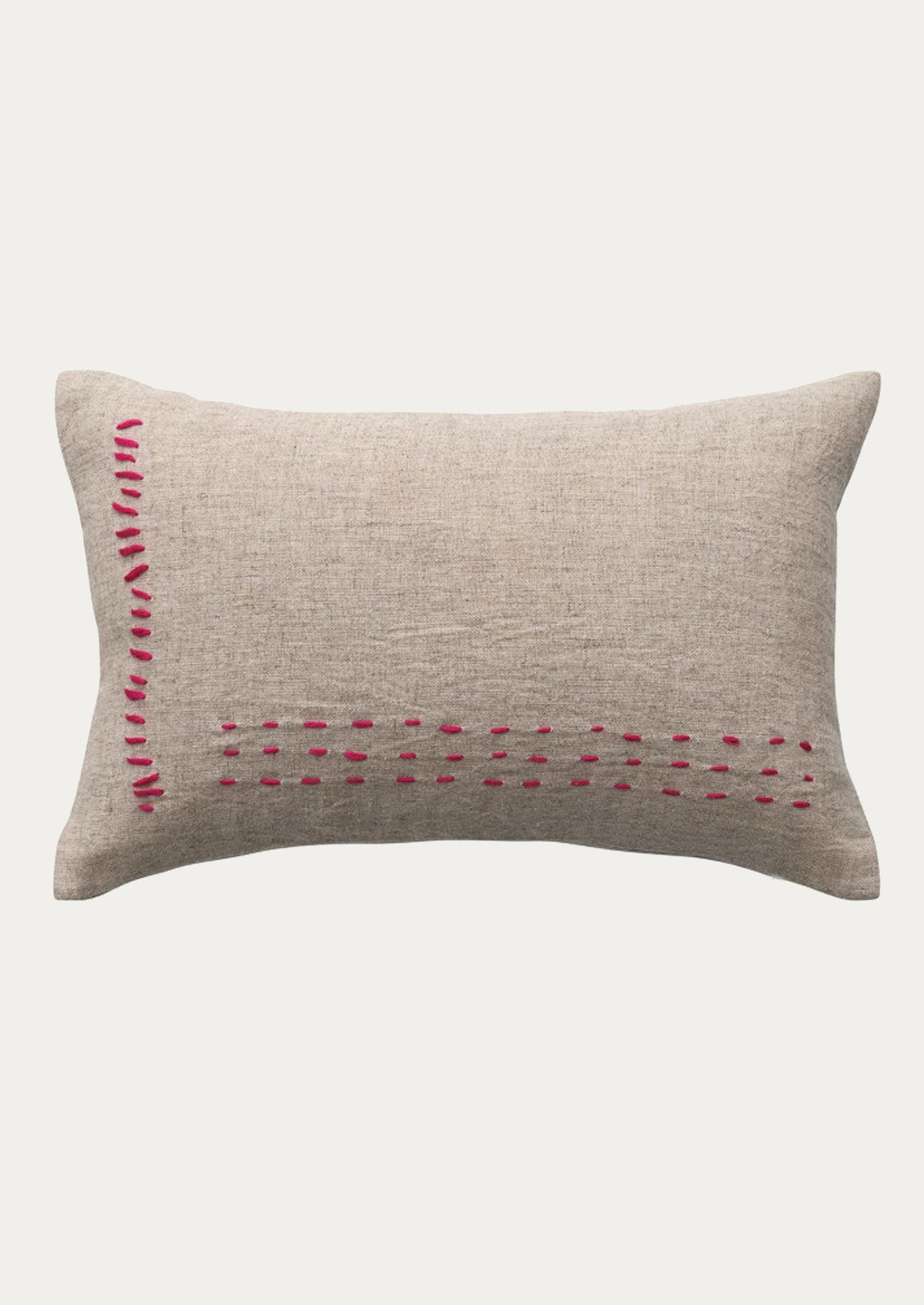 A linen lumbar pillow in natural linen with hot pink stitching.