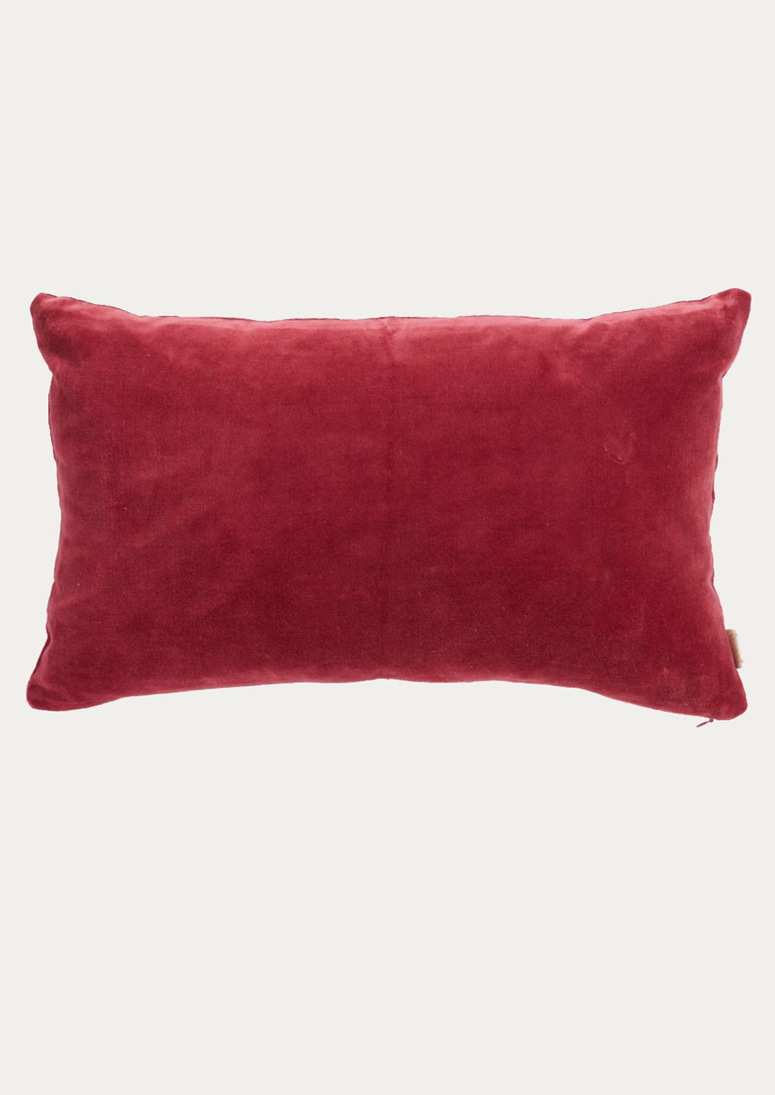 A rectangular berry velvet lumbar pillow.