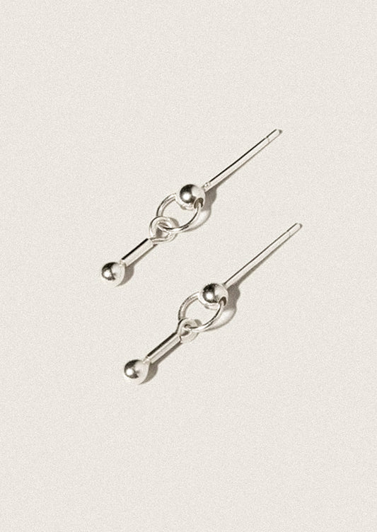 A pair of sterling silver stud earrings in dangling barbell shape.
