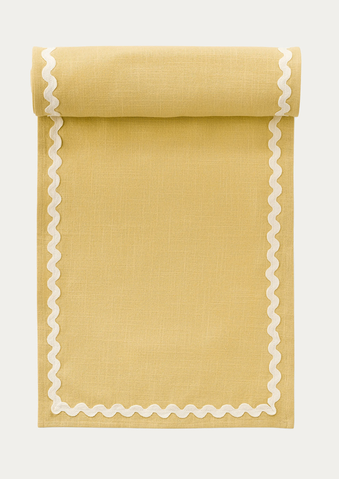 A butter yellow table runner with white ricrac border.