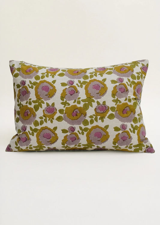 A lumbar throw pillow in purple, ochre and green floral print.