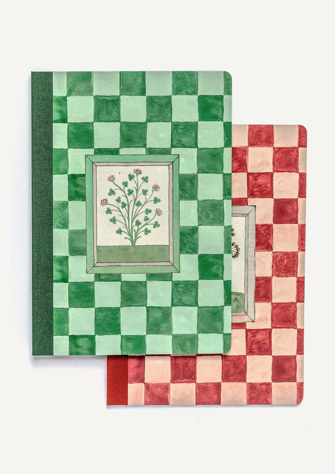 Notebooks in red and green checker prints with botanical illustrations.