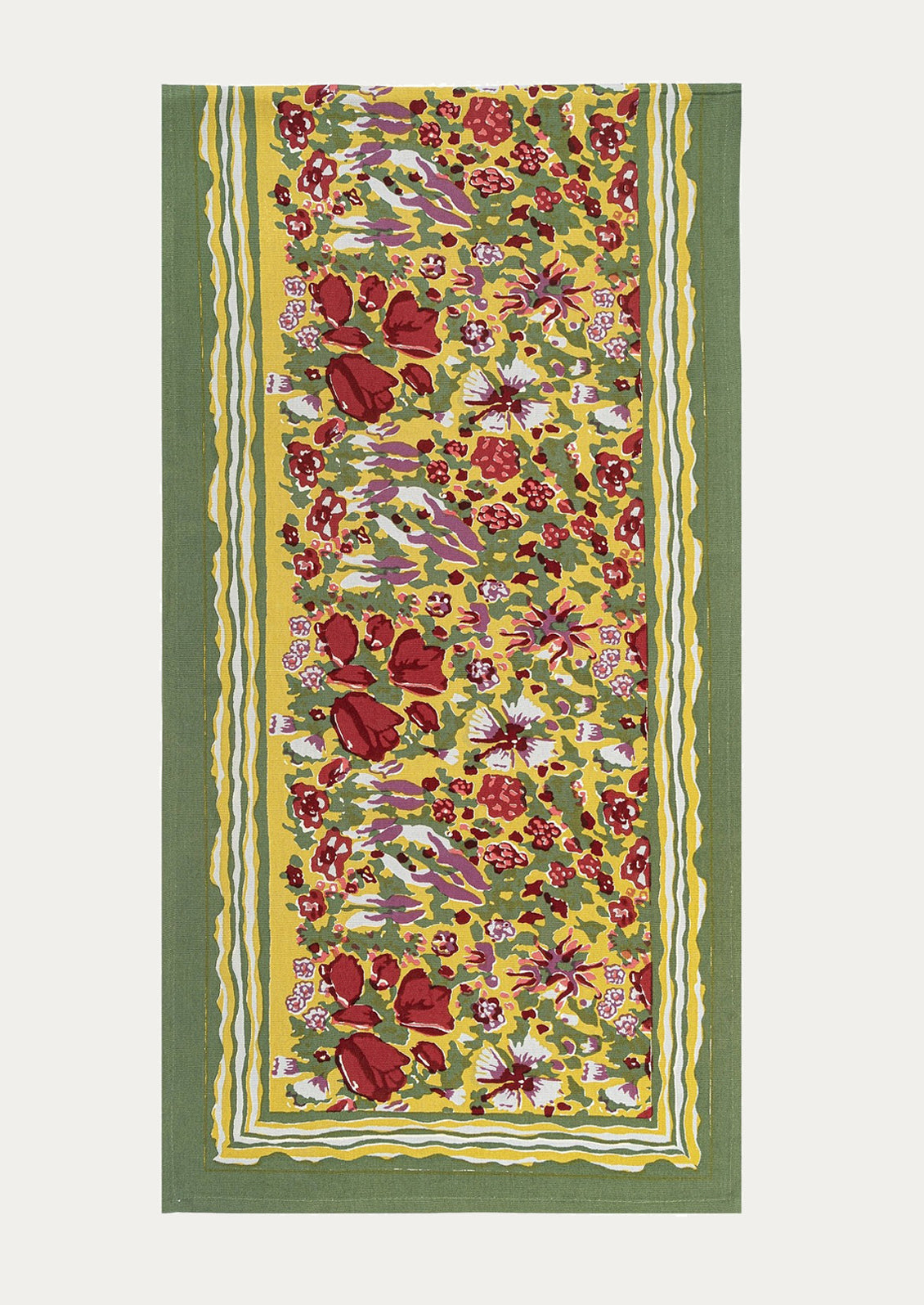A floral patterned table runner in green with red, yellow, white and purple pattern.