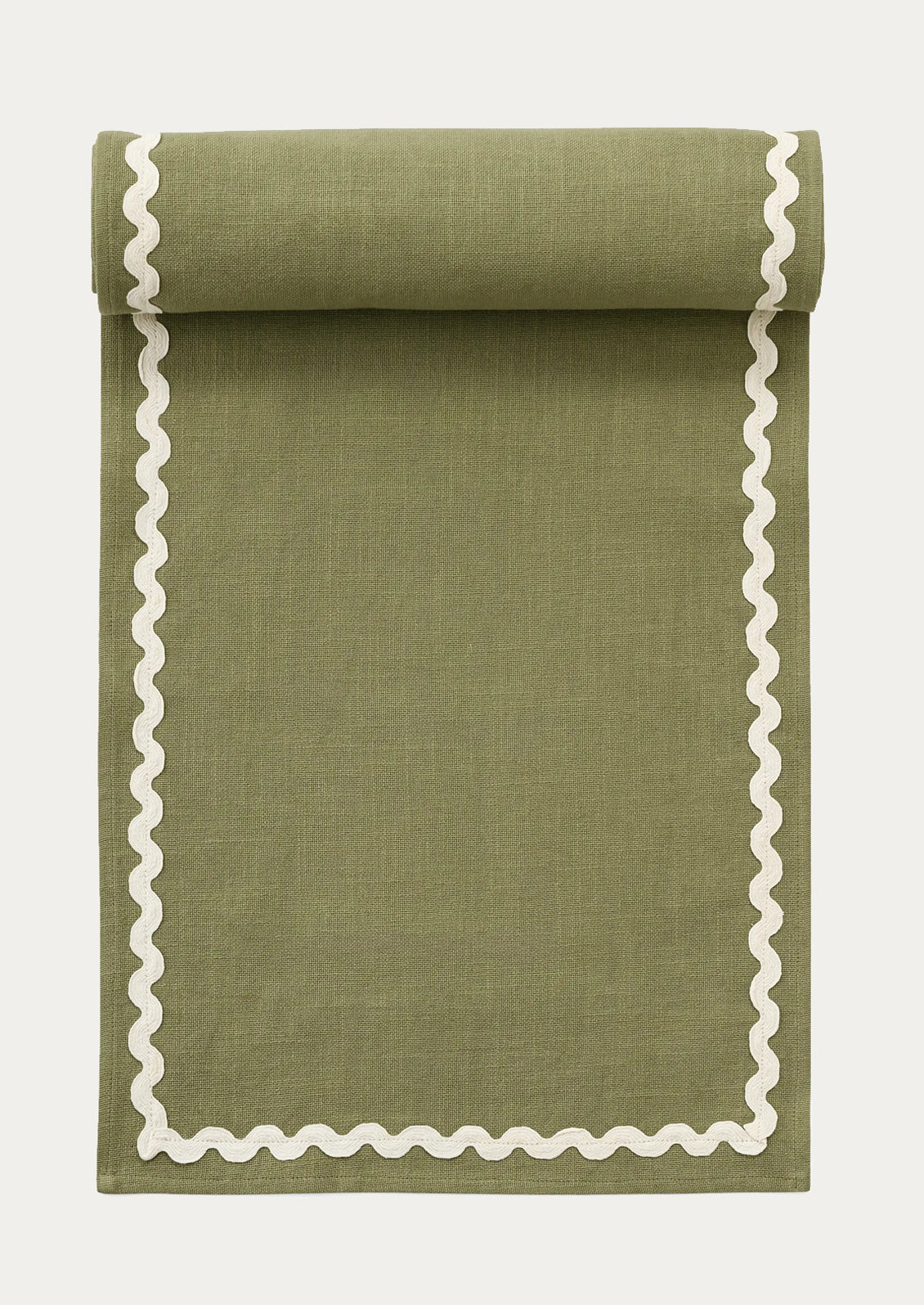 A moss green table runner with white ricrac border.