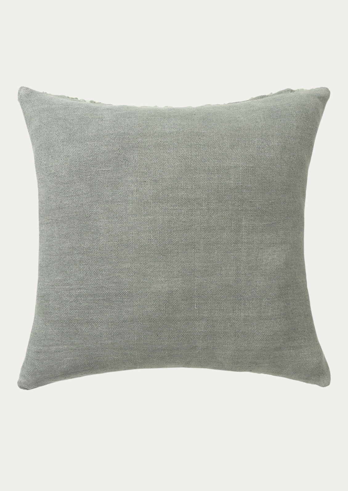 The back of a pillow in a sage green cotton canvas fabric.