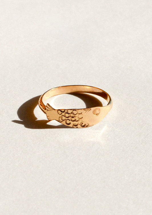 A gold ring in the shape of a sardine.