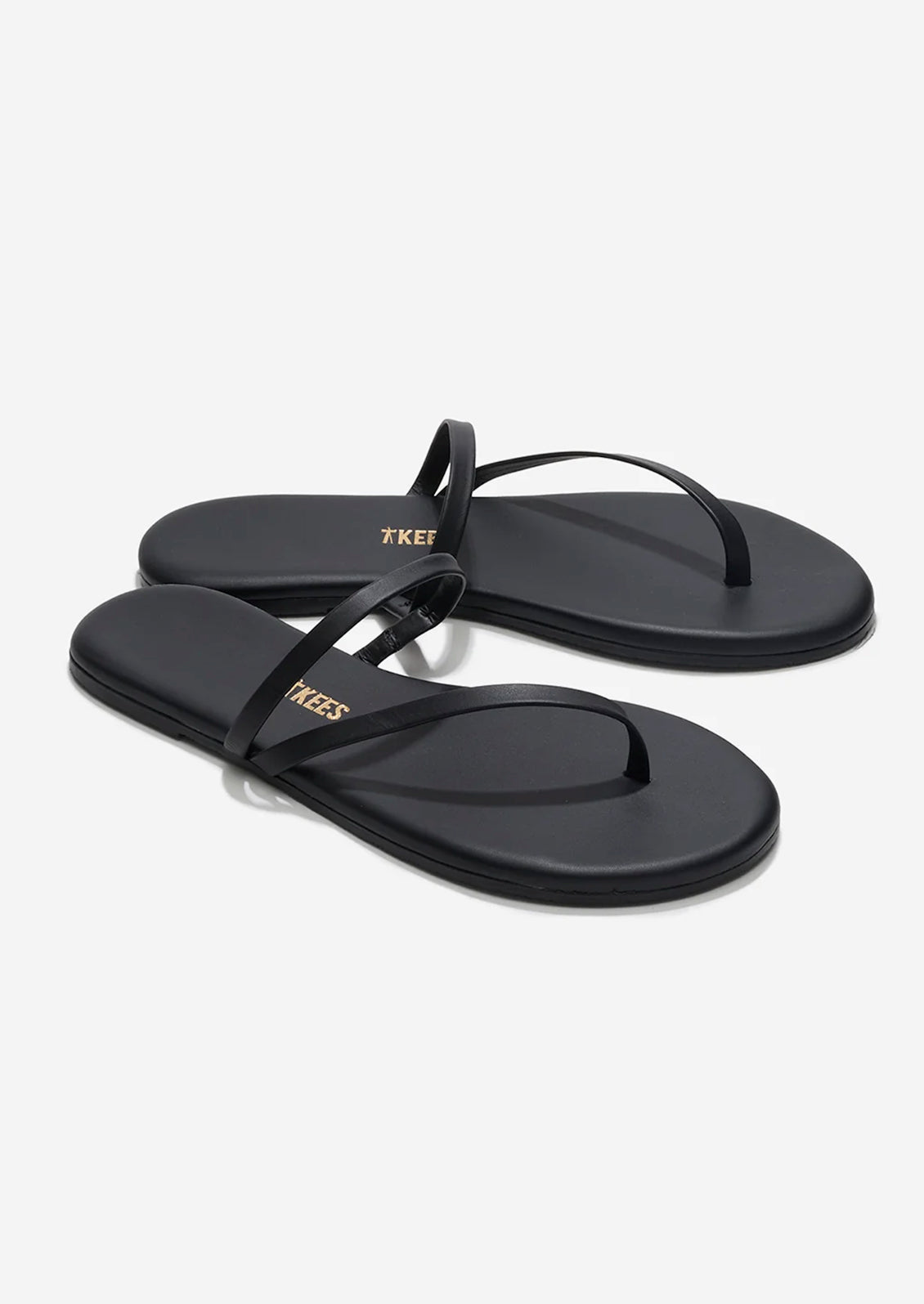 A pair of black leather strappy sandals by TKEES.