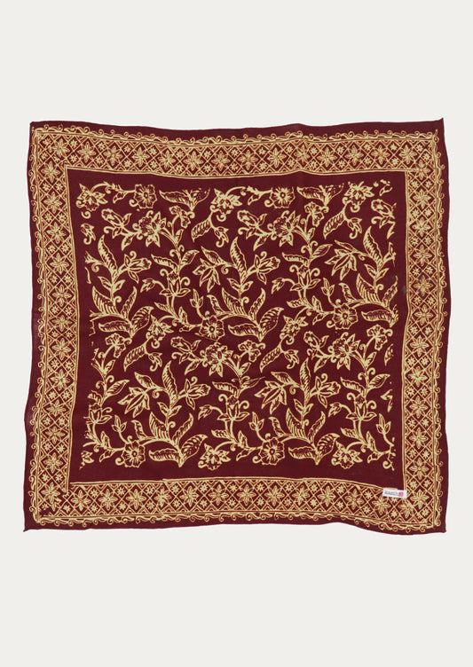A square cotton scarf in burgundy and ivory floral pattern.