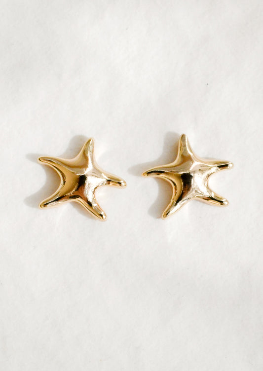 A pair of gold star shaped earrings with melty look.