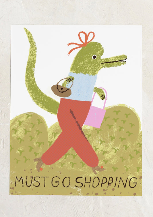 Cartoon crocodile wearing a blue shirt, red pants, and carrying bags with text 'Must Go Shopping' on a light background.