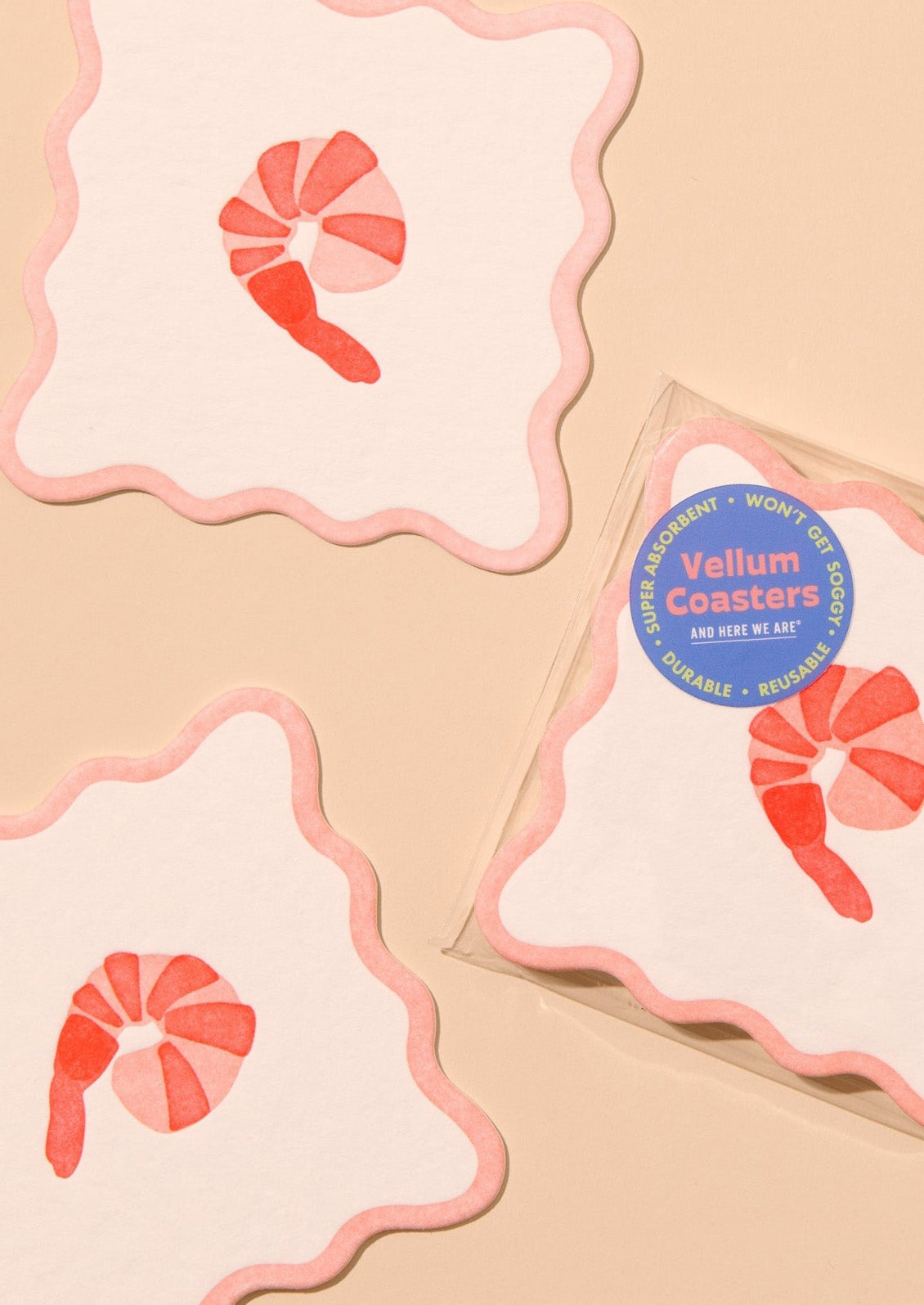 Decorative paper coasters with wavy edges and shrimp motif.