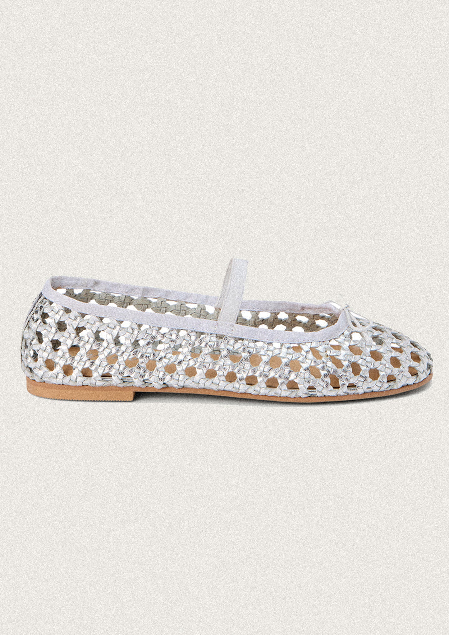 A pair of open weave leather ballet flats in silver.