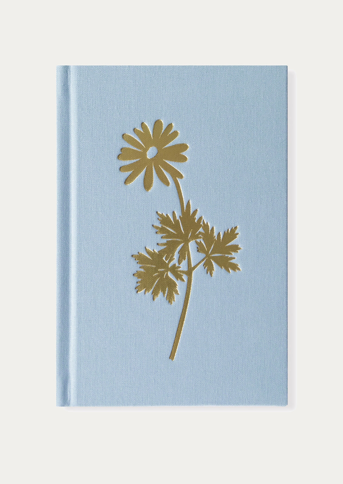 Blue notebook with a gold floral design on a white background
