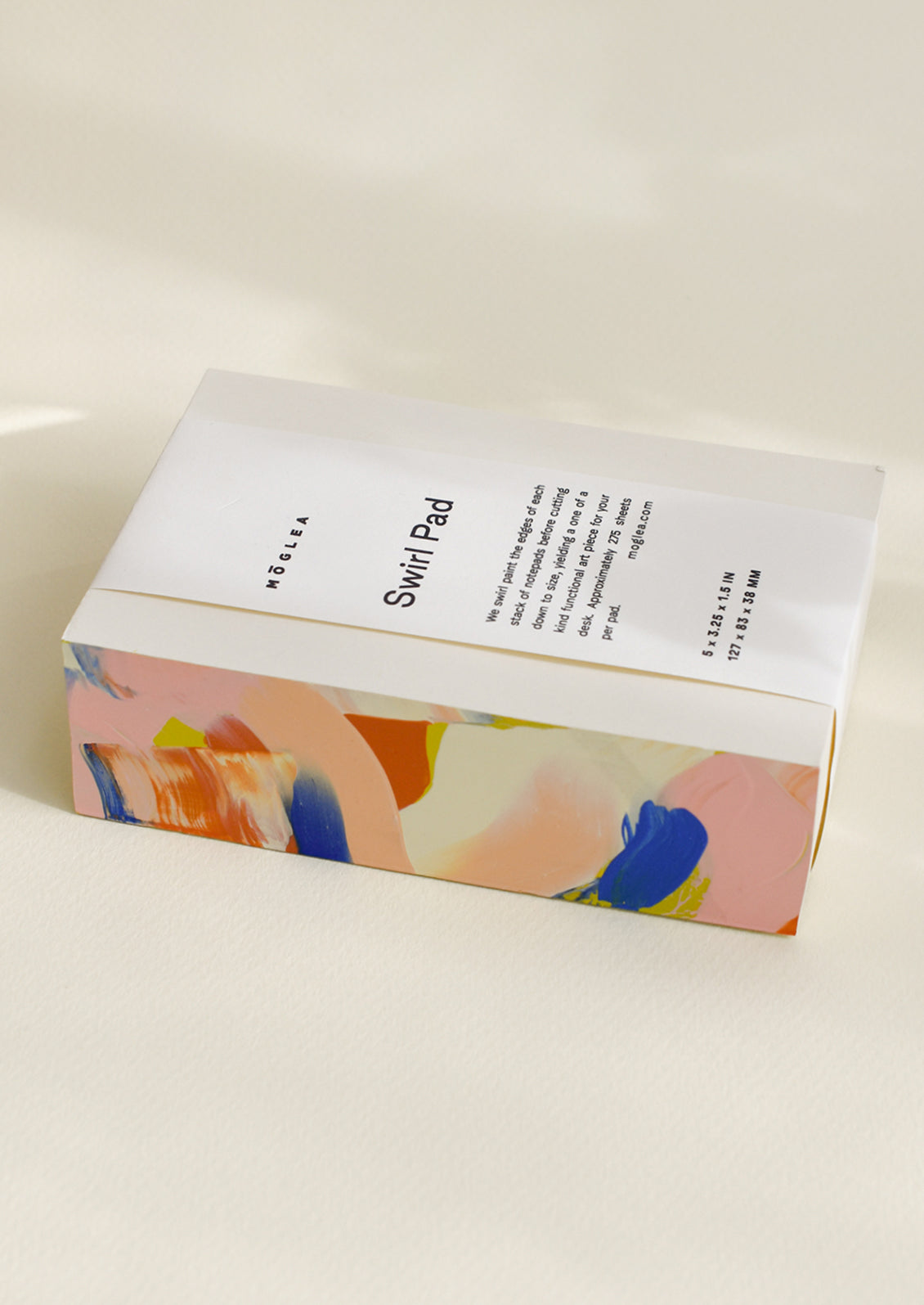 A chunky notepad with rainbow painted side.