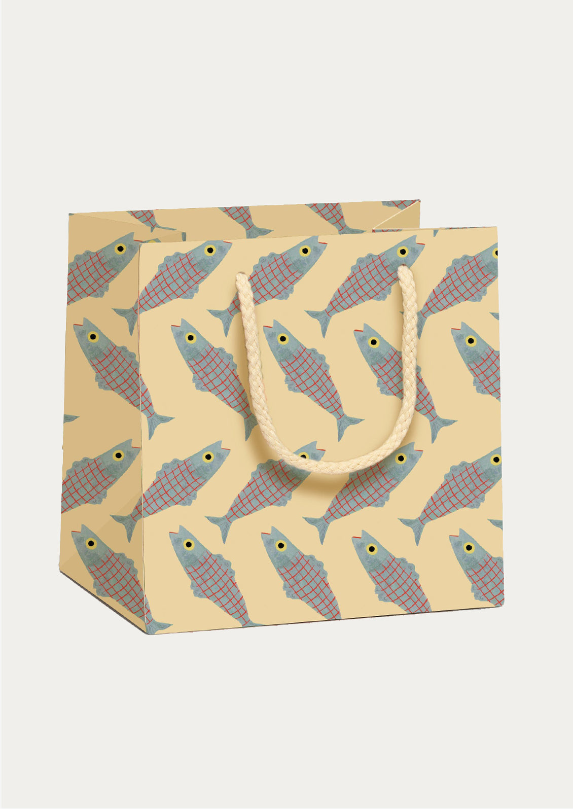 Patterned gift bag with fish pattern on pale yellow background.
