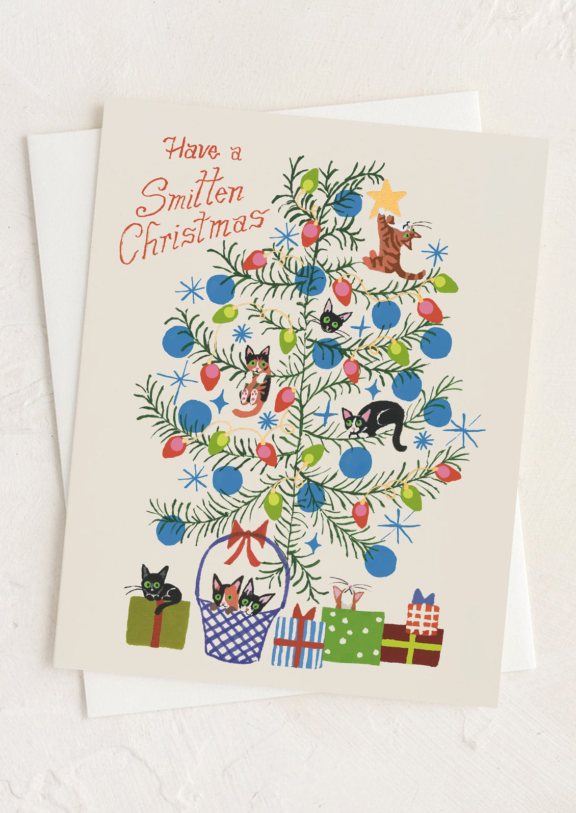 A card with illustration of cats in a tree, text reads "Have a smitten christmas".